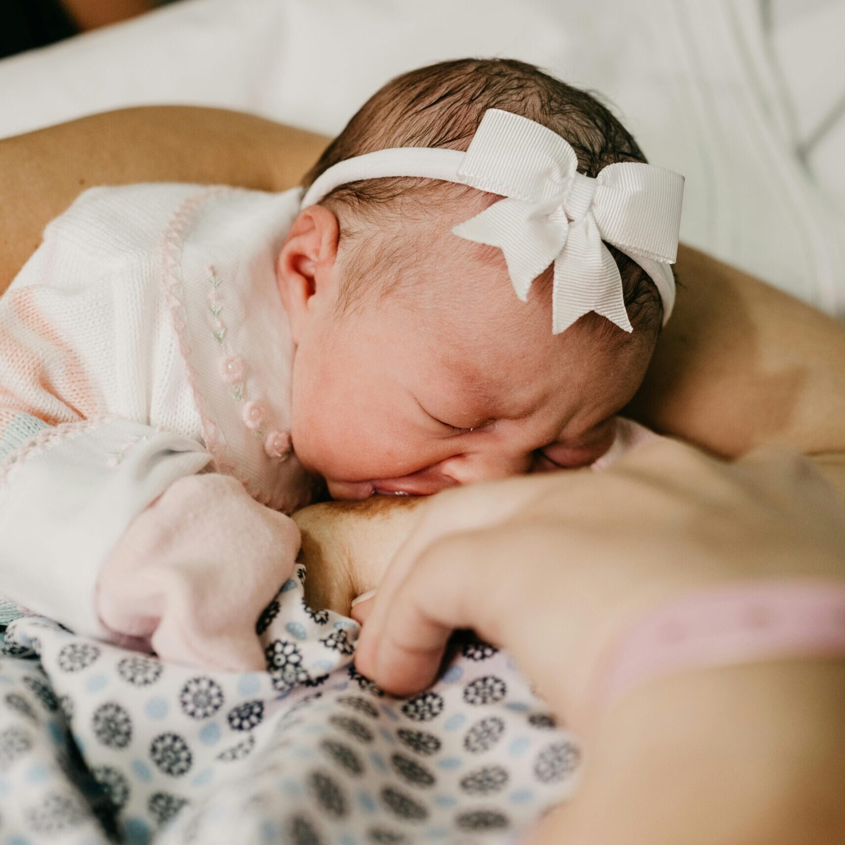 A touching scene of a newborn baby breastfeeding, symbolizing innocence and motherhood.
